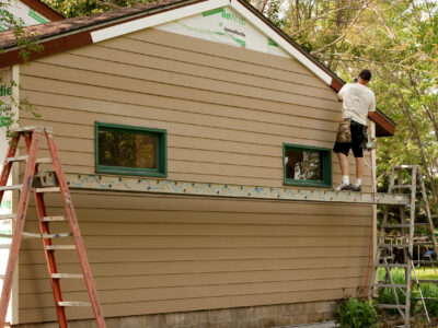 River,Falls,wisconsin-july,23,2015:,A,Worker,Installs,Hardie,Board,Siding,And